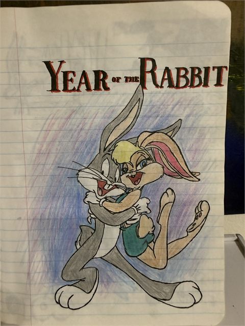 A coloured pencil drawing on lined paper of a cartoon rabbit beneath hand-lettered words reading Year of the Rabbit.