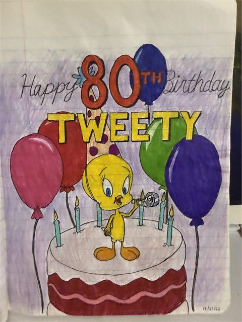 A coloured pencil drawing of a yellow cartoon bird perched on a large birthday cake with balloons.