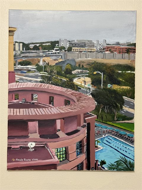 An acrylic painting of rose and terracotta waterfront buildings with palm trees and a swimming pool below a pale blue sky.